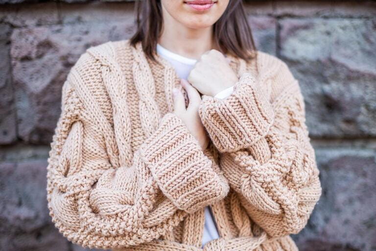 Girl standing in a handmade cardigan Girl standing in a handmade cardigan