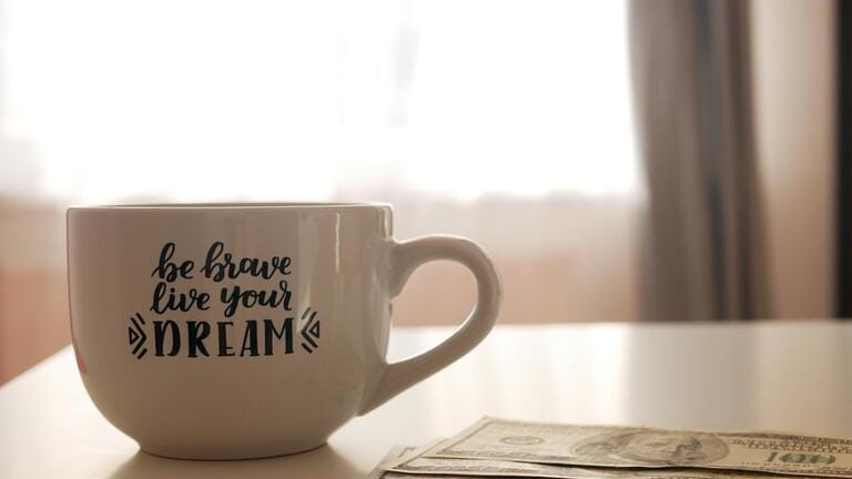 Men's hand count money on the background of a motivating inscription. Success.